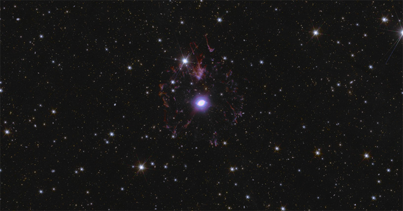 This is a zoom-in of Euclid’s Deep Field North, showing the Cat’s Eye Nebula in the centre of the image, around 3000 light-years away. Also known as NGC 6543, this nebula is a visual ‘fossil record’ of the dynamics and late evolution of a dying star. This dying star is shedding its outer colourful shells. Credit: ESA/Euclid/Euclid Consortium/NASA, image processing by J.-C. Cuillandre, E. Bertin, G